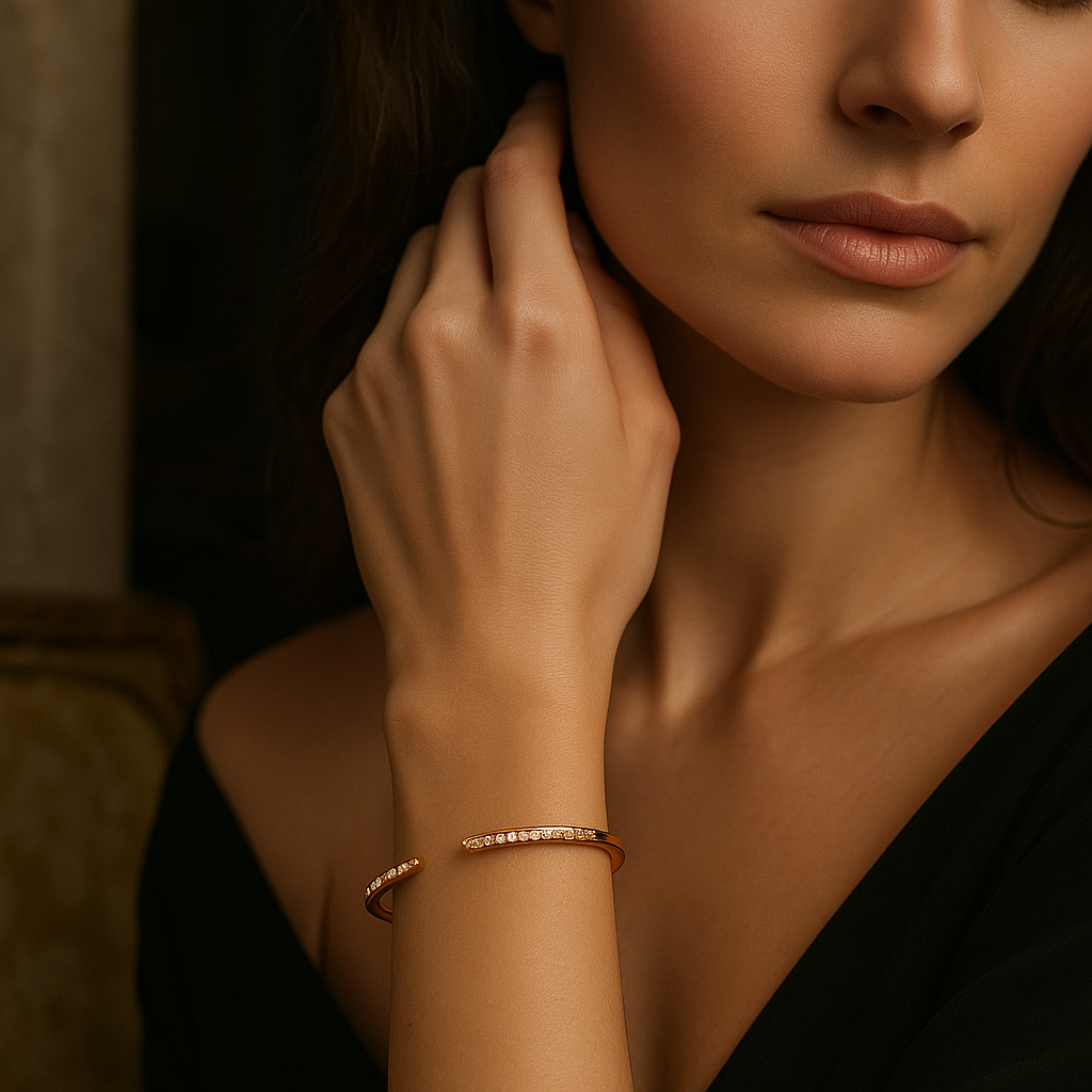 Close-up of a woman wearing a rose gold bracelet on a dark background